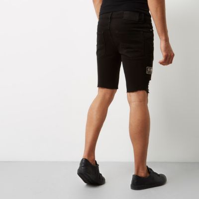 Black frayed badge skinny denim shorts